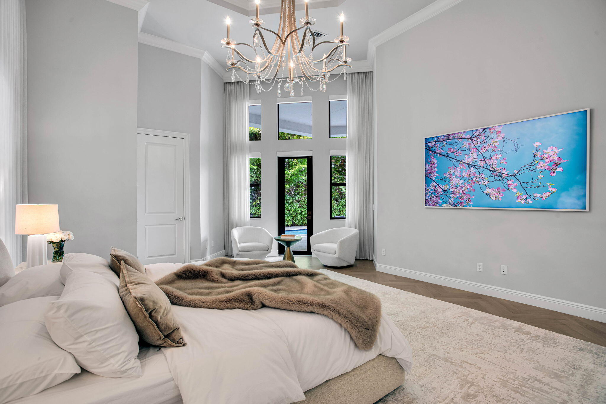 6903 Northwest 28th Avenue Boca Raton, FL 33496 - Photo 20 of 55 a bedroom with a large bed chandelier and a window