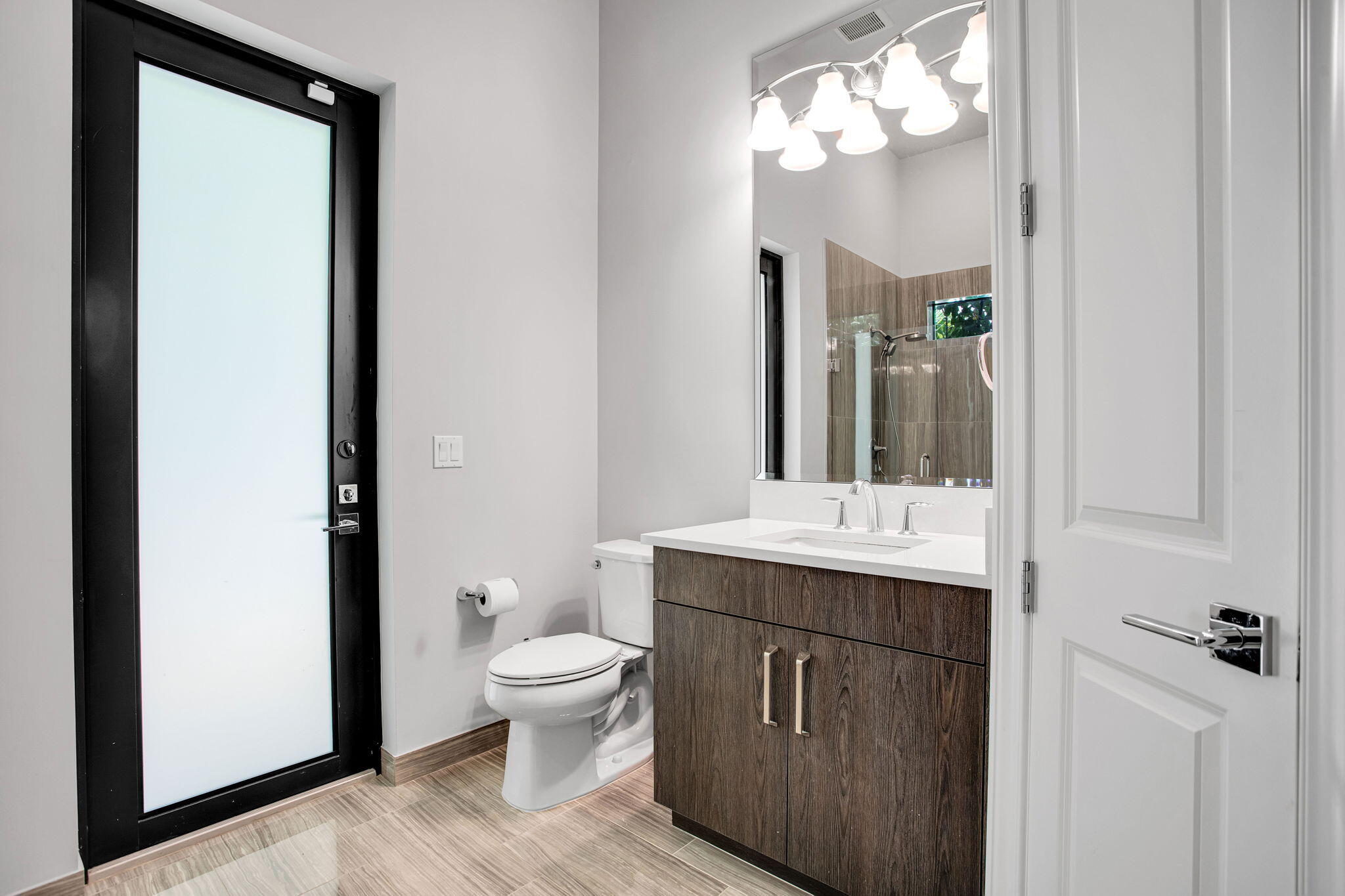6903 Northwest 28th Avenue Boca Raton, FL 33496 - Photo 25 of 55 a bathroom with a sink a toilet and a mirror