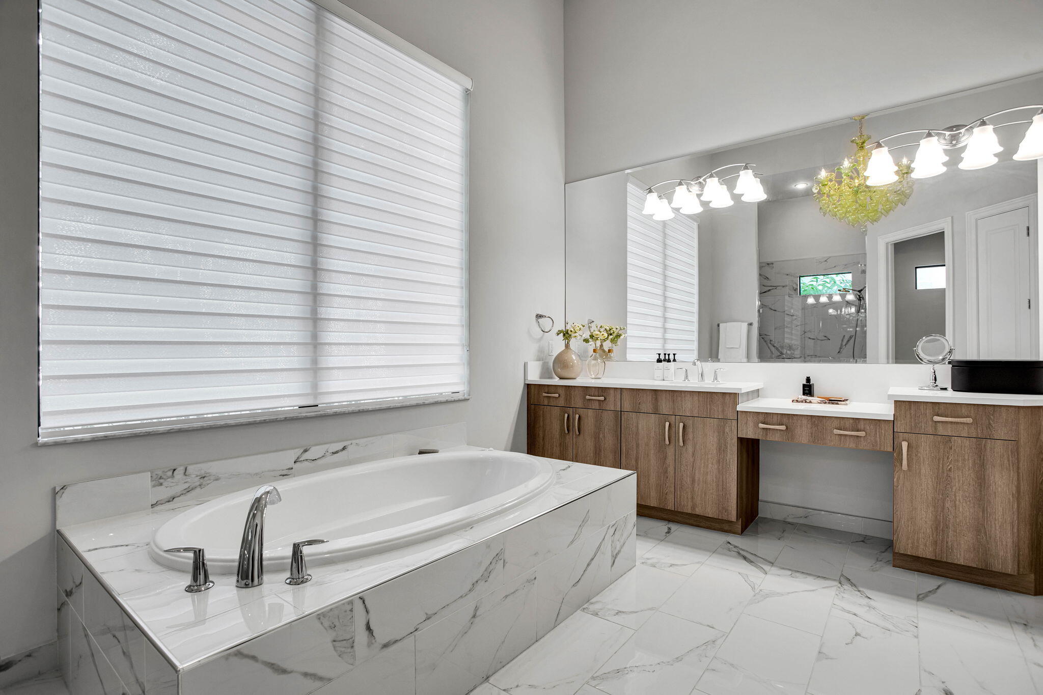 6903 Northwest 28th Avenue Boca Raton, FL 33496 - Photo 27 of 55 a bathroom with a tub a sink and a large mirror