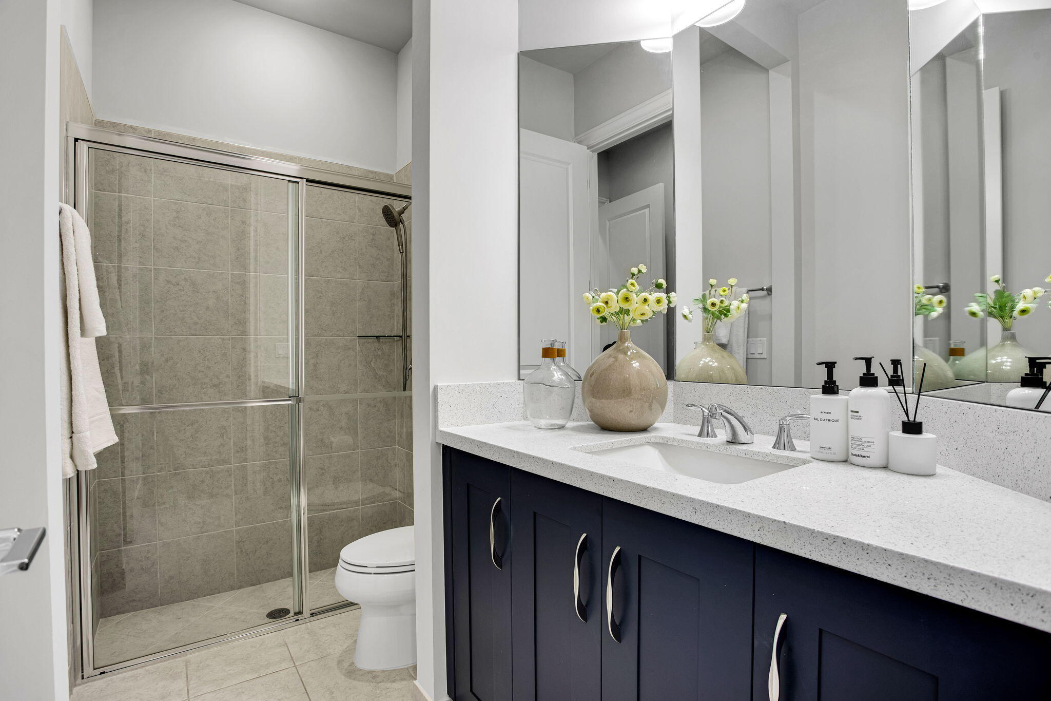 6903 Northwest 28th Avenue Boca Raton, FL 33496 - Photo 31 of 55 a bathroom with a granite countertop sink a toilet and shower