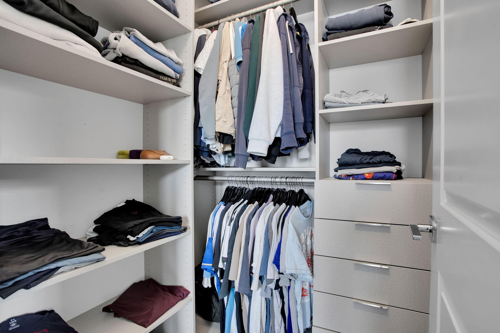 6903 Northwest 28th Avenue Boca Raton, FL 33496 - Photo 49 of 55 a view of walk in closet with clothes and shoes