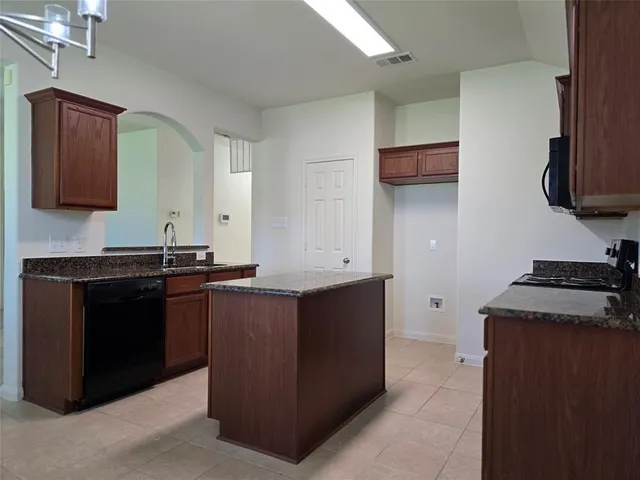 a kitchen with stainless steel appliances granite countertop a stove and a sink