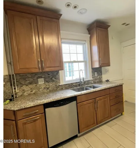 a kitchen with granite countertop stainless steel appliances sink and cabinets