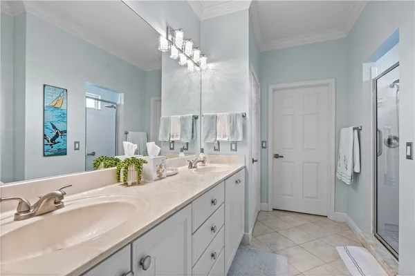 a spacious bathroom with a double vanity sink mirror and shower