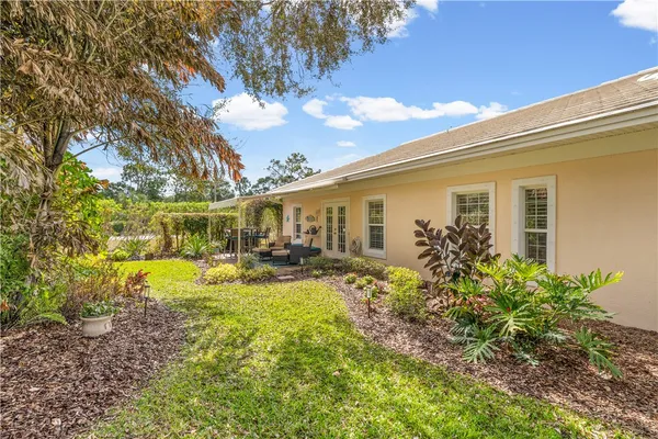 a view of a house with backyard and sitting area