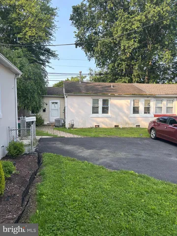 a front view of a house with a garden and yard