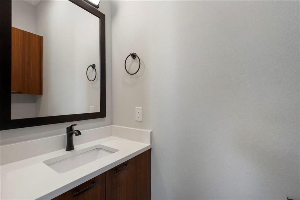 1107 Stobaugh Street, Unit 1 Austin, TX 78757 - Photo 10 of 27 a bathroom with a sink and a mirror