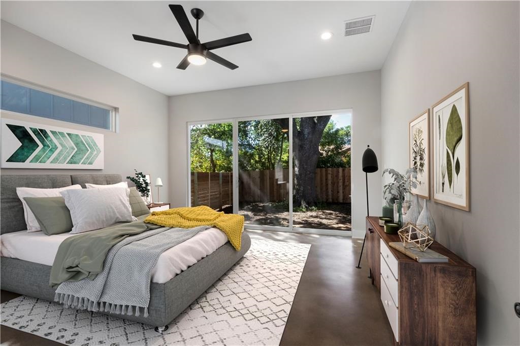 1107 Stobaugh Street, Unit 1 Austin, TX 78757 - Photo 12 of 27 a bedroom with a bed couch and a large window