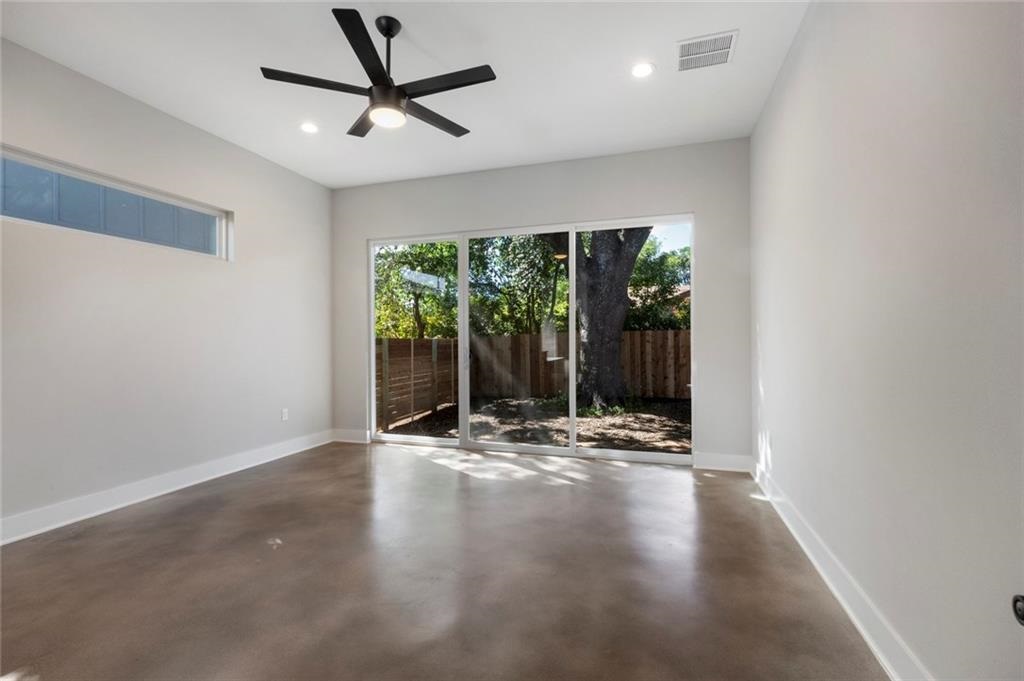 1107 Stobaugh Street, Unit 1 Austin, TX 78757 - Photo 13 of 27 a view of an empty room with wooden floor and a window