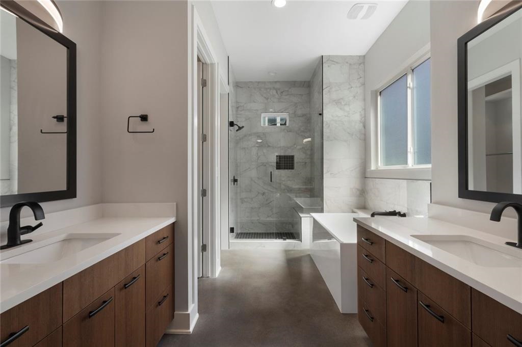1107 Stobaugh Street, Unit 1 Austin, TX 78757 - Photo 14 of 27 a bathroom with a sink double vanity and a shower