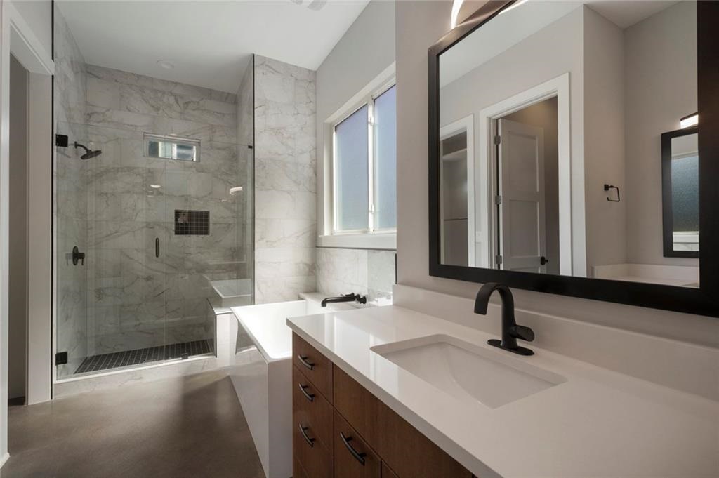 1107 Stobaugh Street, Unit 1 Austin, TX 78757 - Photo 15 of 27 a bathroom with a sink double vanity and a mirror