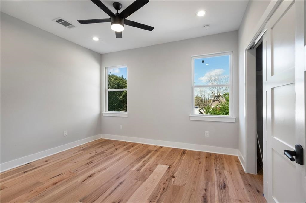 1107 Stobaugh Street, Unit 1 Austin, TX 78757 - Photo 20 of 27 wooden floor in an empty room with a window