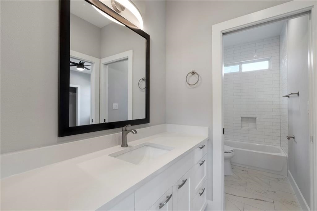 1107 Stobaugh Street, Unit 1 Austin, TX 78757 - Photo 22 of 27 a bathroom with a sink and a mirror