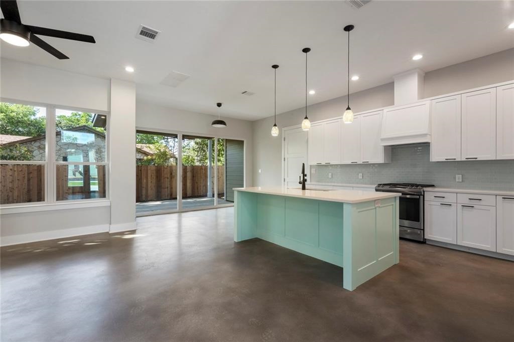 1107 Stobaugh Street, Unit 1 Austin, TX 78757 - Photo 8 of 27 a large kitchen with stainless steel appliances kitchen island a large island in the center