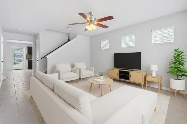 a living room with furniture and a flat screen tv