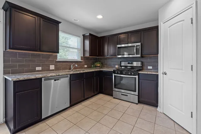 a kitchen with a sink stove and microwave