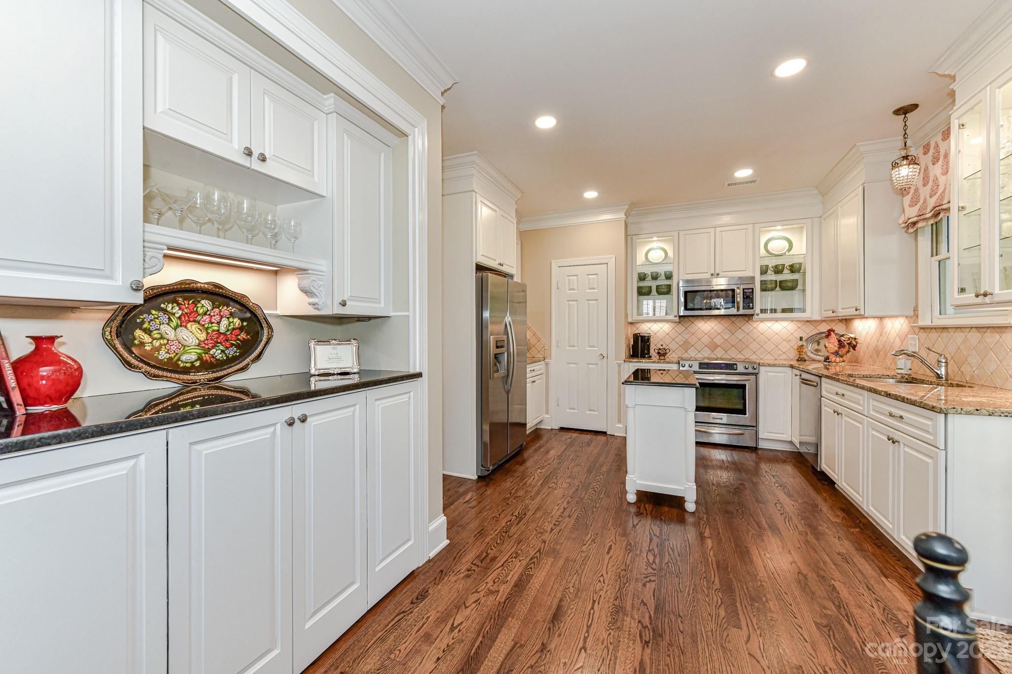 130 Morrison Hill Road Davidson, NC 28036 - Photo 11 of 29 a kitchen with a refrigerator and a stove top oven