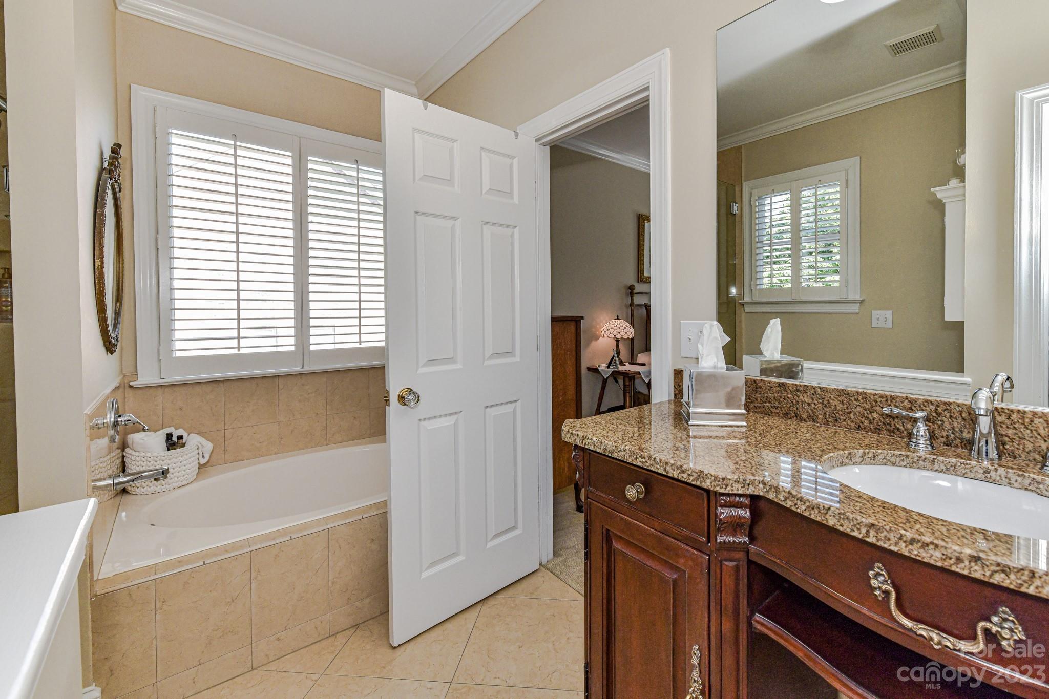 130 Morrison Hill Road Davidson, NC 28036 - Photo 17 of 29 a bathroom with a granite countertop tub sink and mirror