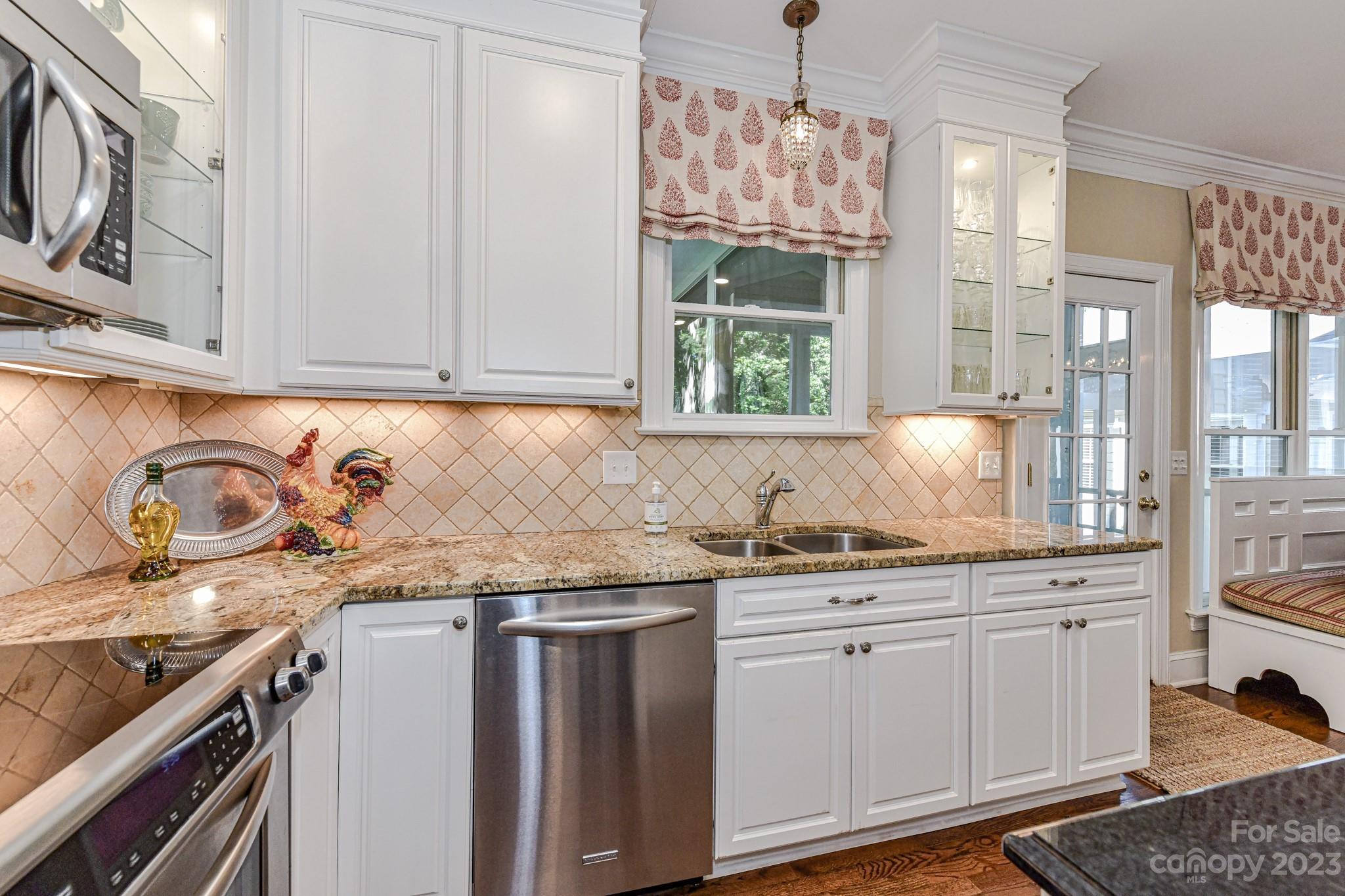 130 Morrison Hill Road Davidson, NC 28036 - Photo 9 of 29 a kitchen with stainless steel appliances granite countertop a sink and a stove