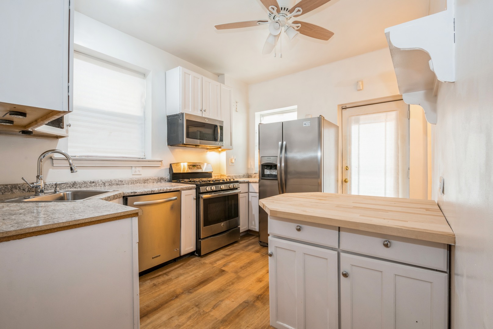 4937 South Prairie Avenue Chicago, IL 60615 - Photo 4 of 15 a kitchen with kitchen island granite countertop stainless steel appliances a sink stove refrigerator and cabinets