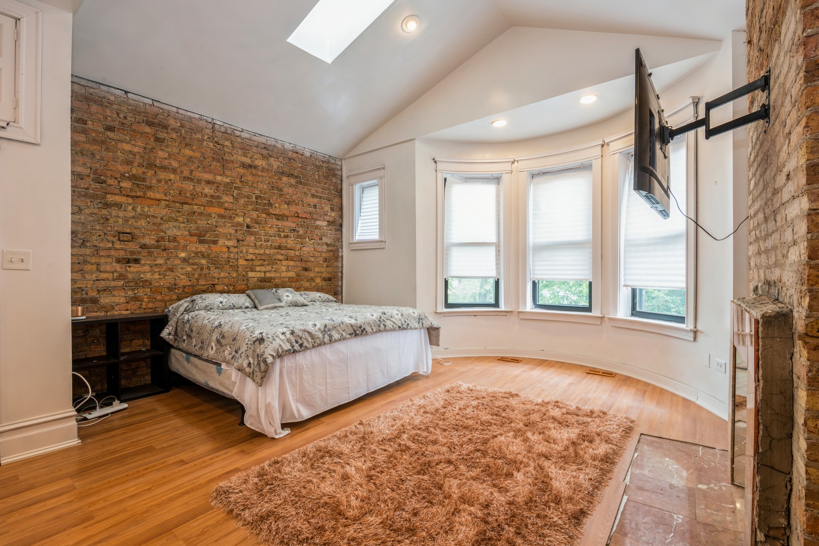 4937 South Prairie Avenue Chicago, IL 60615 - Photo 6 of 15 a bedroom with a bed lamp and a large window