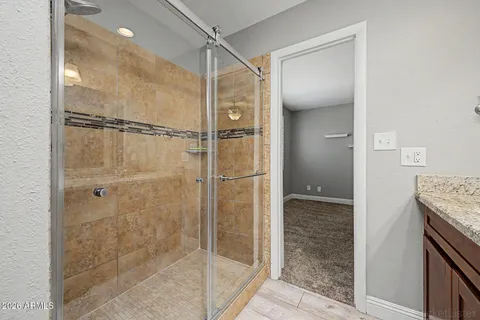 a bathroom with a shower and a sink