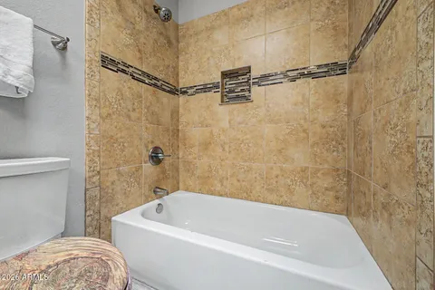 a bathroom with a white bath tub and a shower