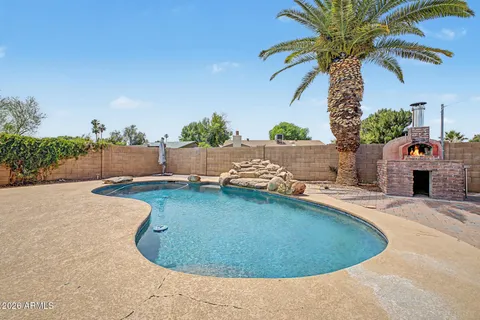 a view of a swimming pool with an outdoor seating
