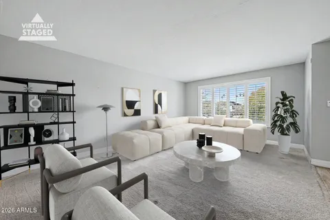 a living room with furniture and a potted plant