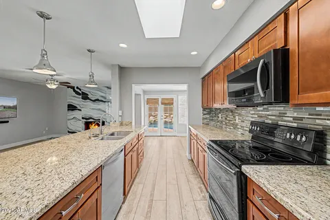 a kitchen with a stove sink and cabinets