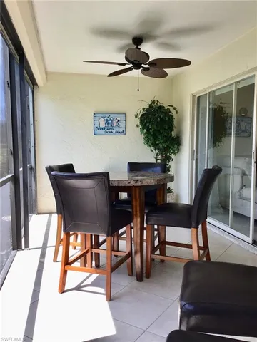 a dining room with furniture and a potted plant