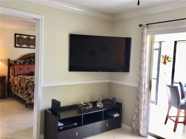 a bedroom with a bed and a television