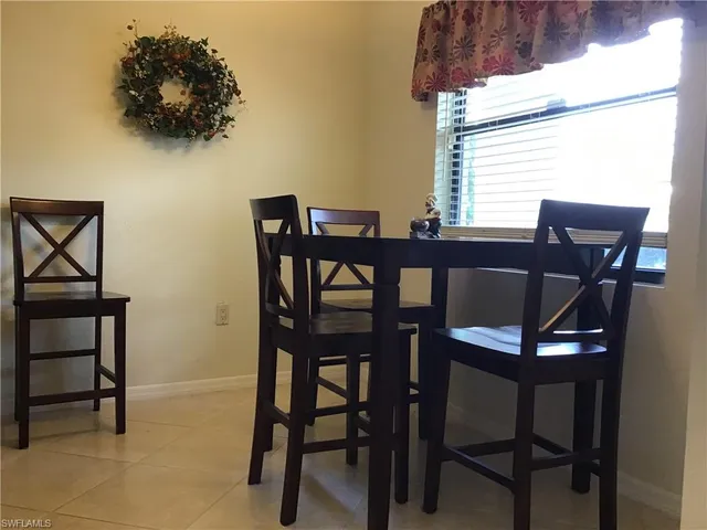 a view of a dining room with furniture and a window