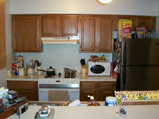 7202 Mansions Drive, Unit F2 Corpus Christi, TX 78414 - Photo 4 of 10 a kitchen with a refrigerator and a stove top oven