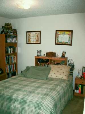 7202 Mansions Drive, Unit F2 Corpus Christi, TX 78414 - Photo 6 of 10 a bedroom with a bed and dresser