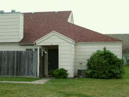 7202 Mansions Drive, Unit F2 Corpus Christi, TX 78414 - Photo 9 of 10 a front view of a house with a garden