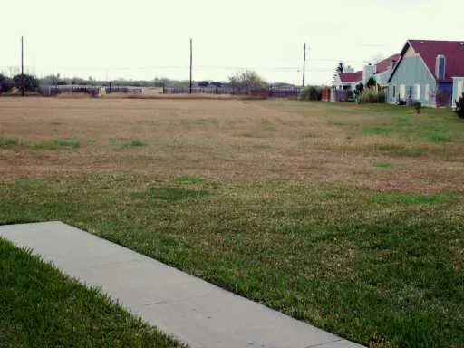 a view of a house next to a yard and a lake view
