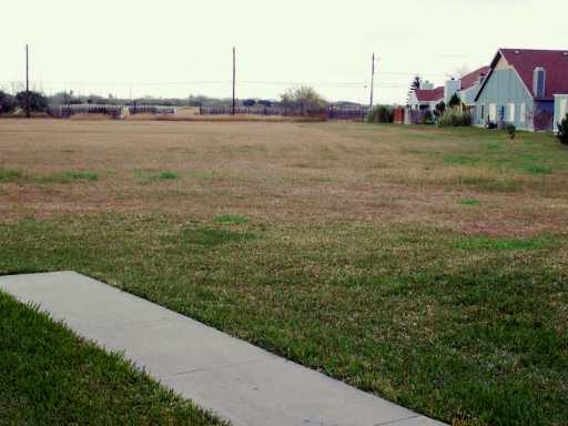 7202 Mansions Drive, Unit F2 Corpus Christi, TX 78414 - Photo 10 of 10 a view of a house next to a yard and a lake view