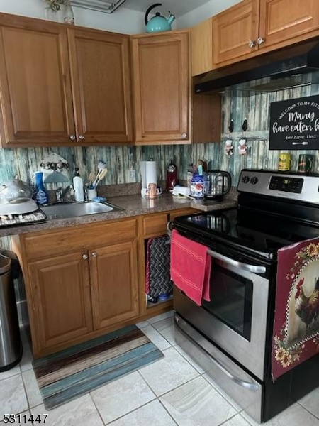 917 Main Street Newton, NJ 07860 - Photo 13 of 14 a kitchen with stainless steel appliances granite countertop a stove a sink and a microwave