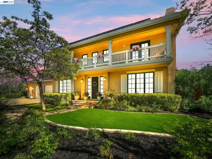 a kitchen with stainless steel appliances granite countertop wooden cabinets a sink and a large window
