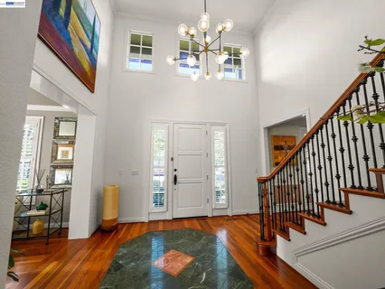a spacious bathroom with a sink a toilet a mirror and shower