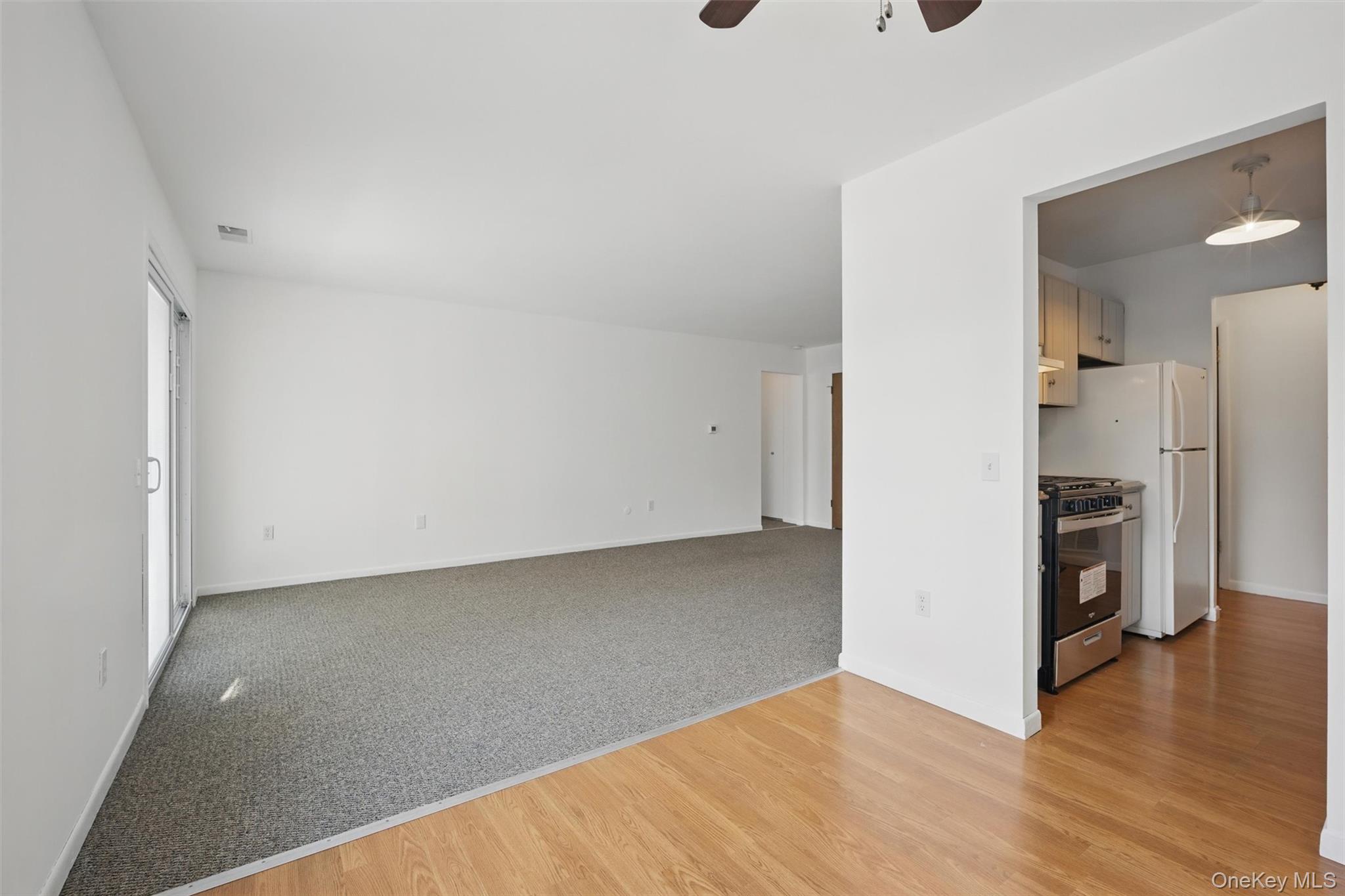 201 Commons Way, Unit E Fishkill, NY 12524 - Photo 12 of 30 a view of a kitchen with a sink and a refrigerator
