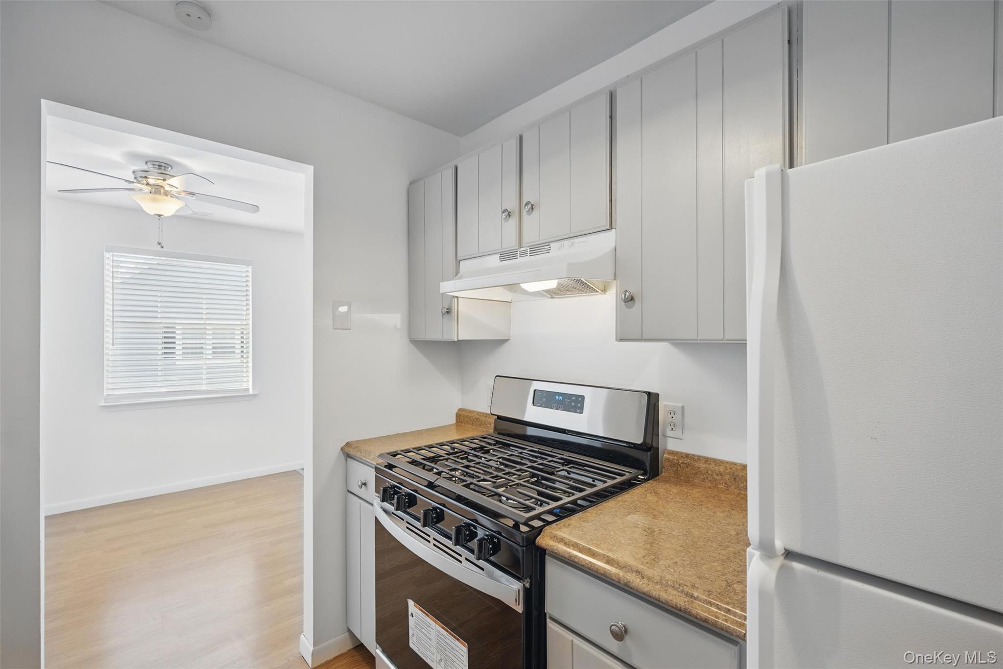 201 Commons Way, Unit E Fishkill, NY 12524 - Photo 15 of 30 a kitchen with white cabinets and appliances