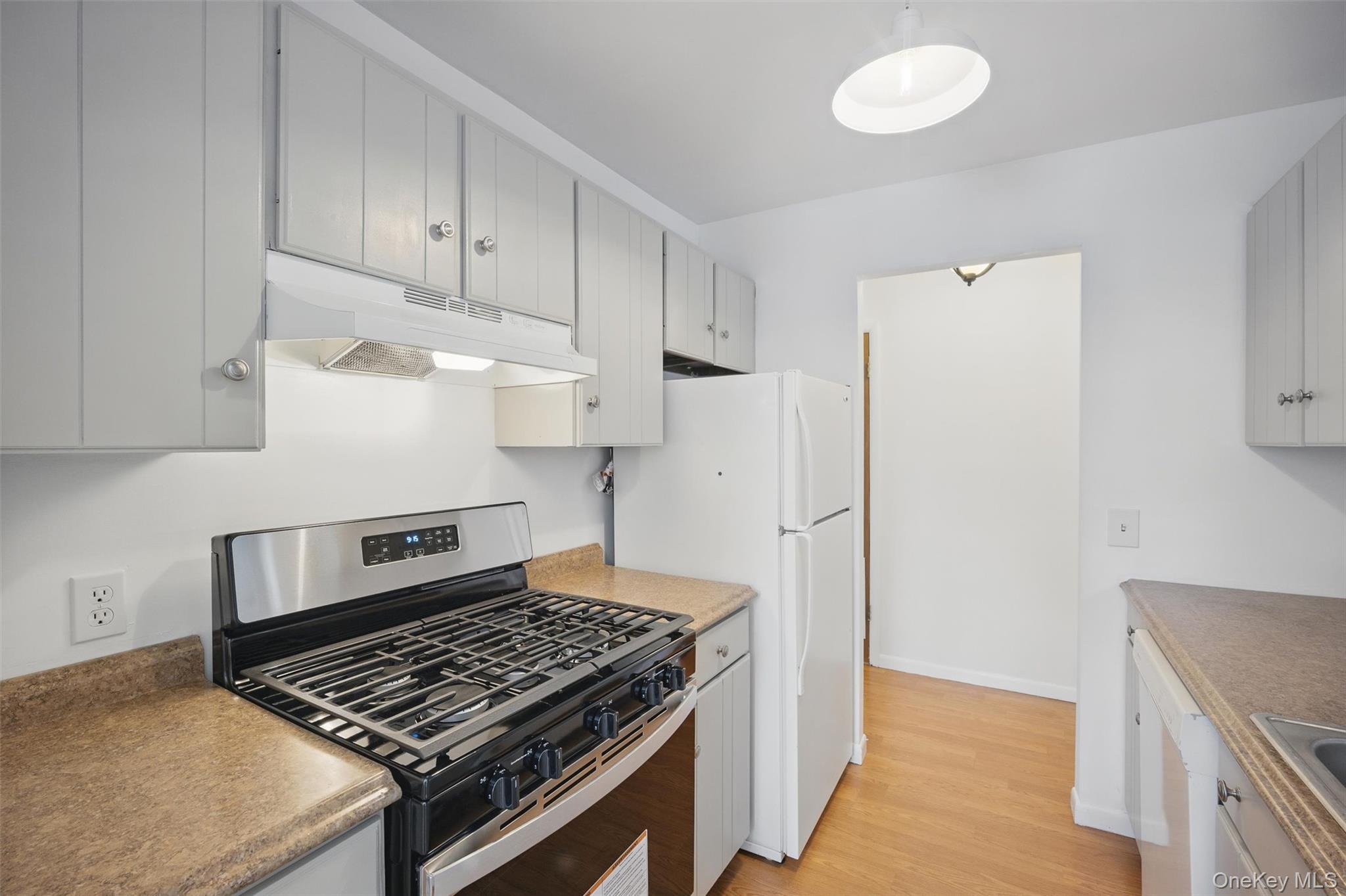 201 Commons Way, Unit E Fishkill, NY 12524 - Photo 17 of 30 a kitchen with white cabinets and white appliances