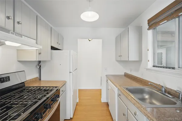 a kitchen that has a sink and a stove