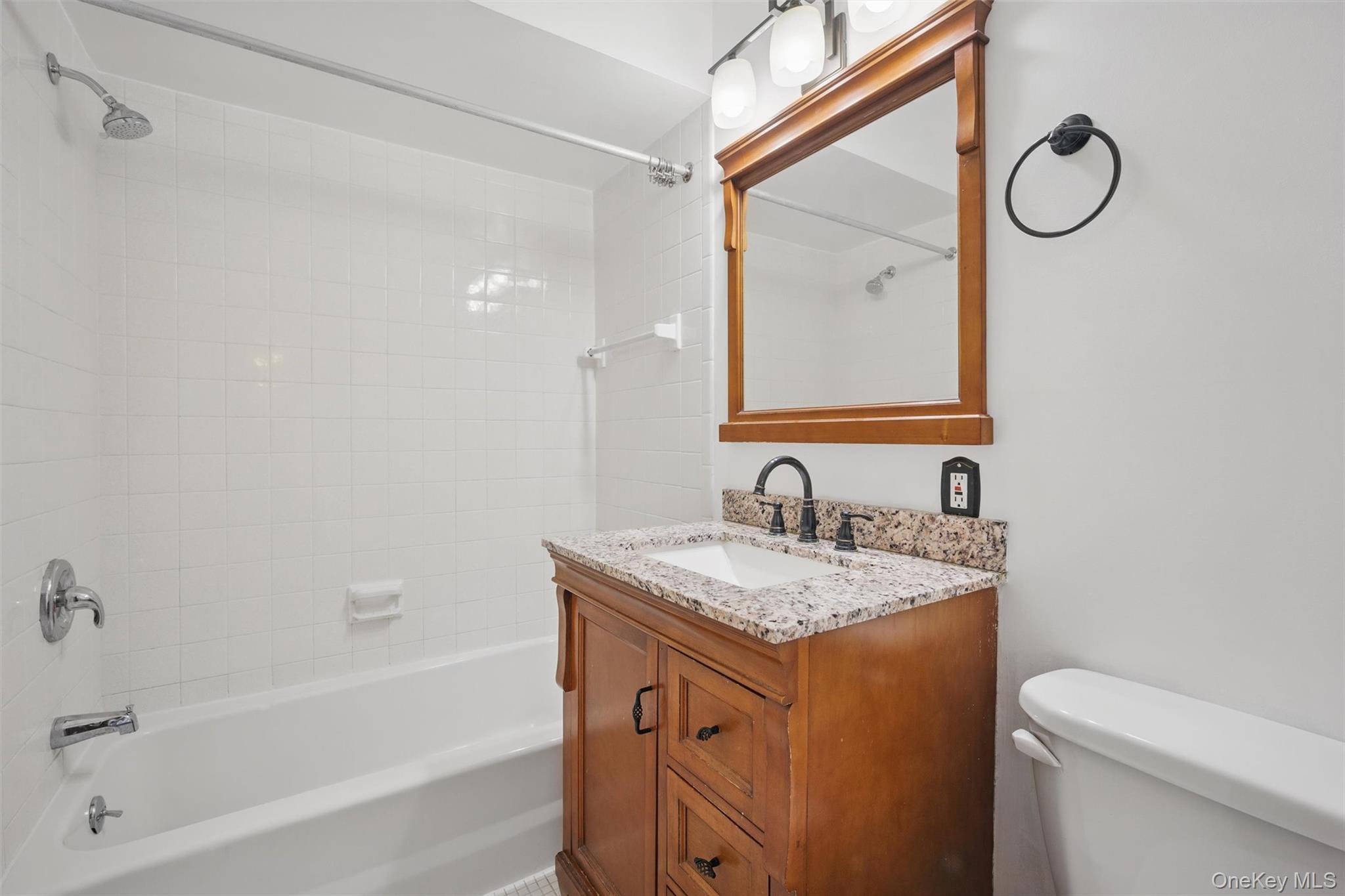 201 Commons Way, Unit E Fishkill, NY 12524 - Photo 19 of 30 a bathroom with a granite countertop sink mirror vanity and toilet