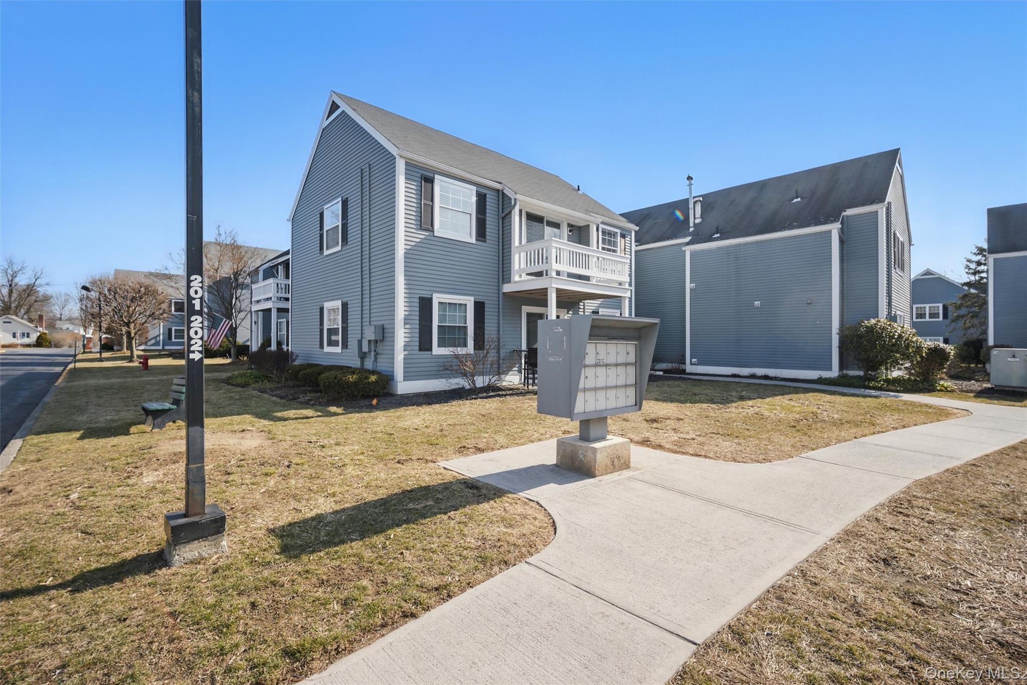 201 Commons Way, Unit E Fishkill, NY 12524 - Photo 2 of 30 a front view of a house with a yard