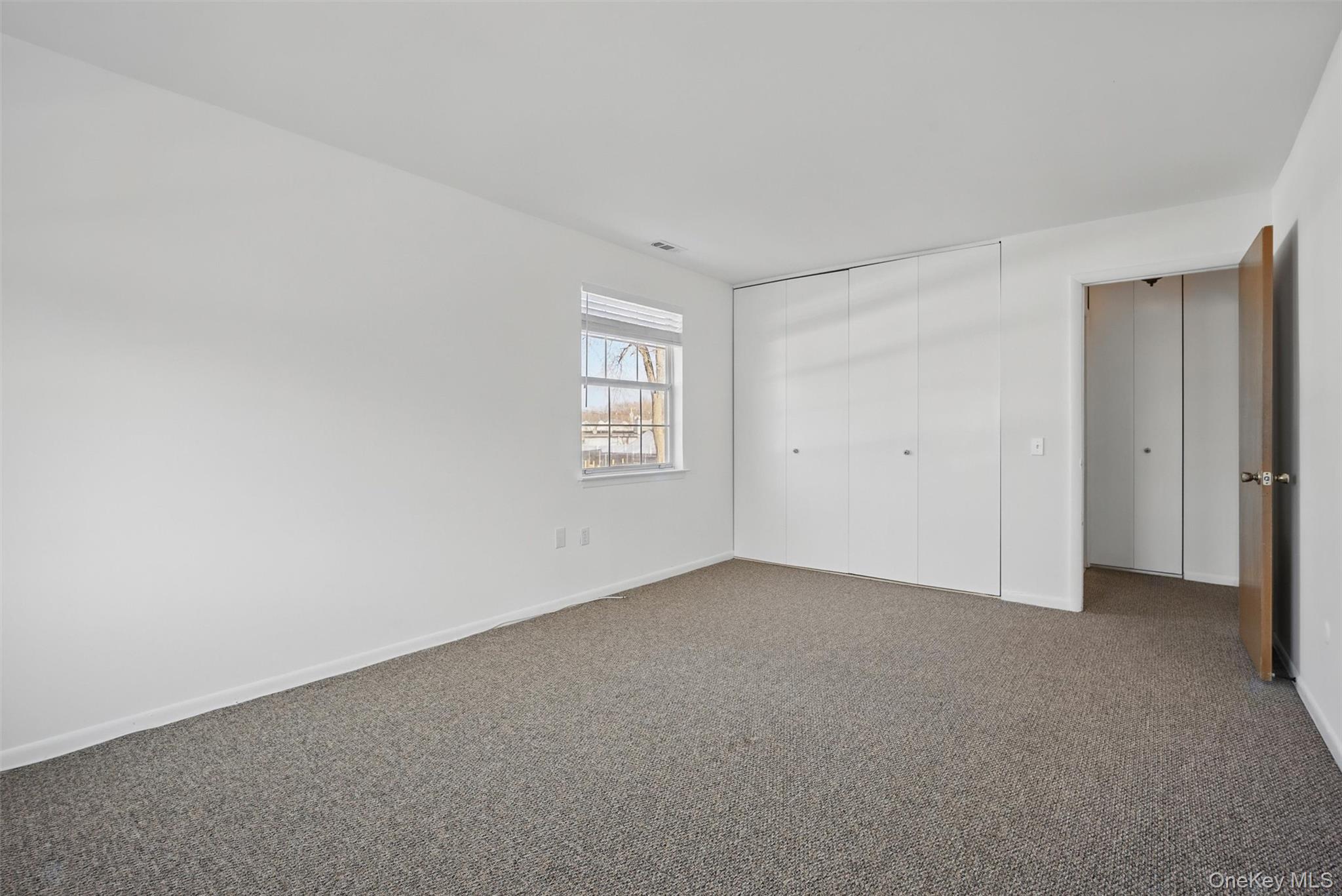 201 Commons Way, Unit E Fishkill, NY 12524 - Photo 21 of 30 a view of an empty room with a window