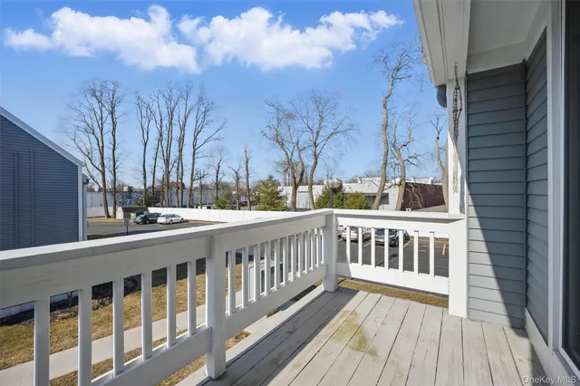 a view of balcony with wooden floor and fence