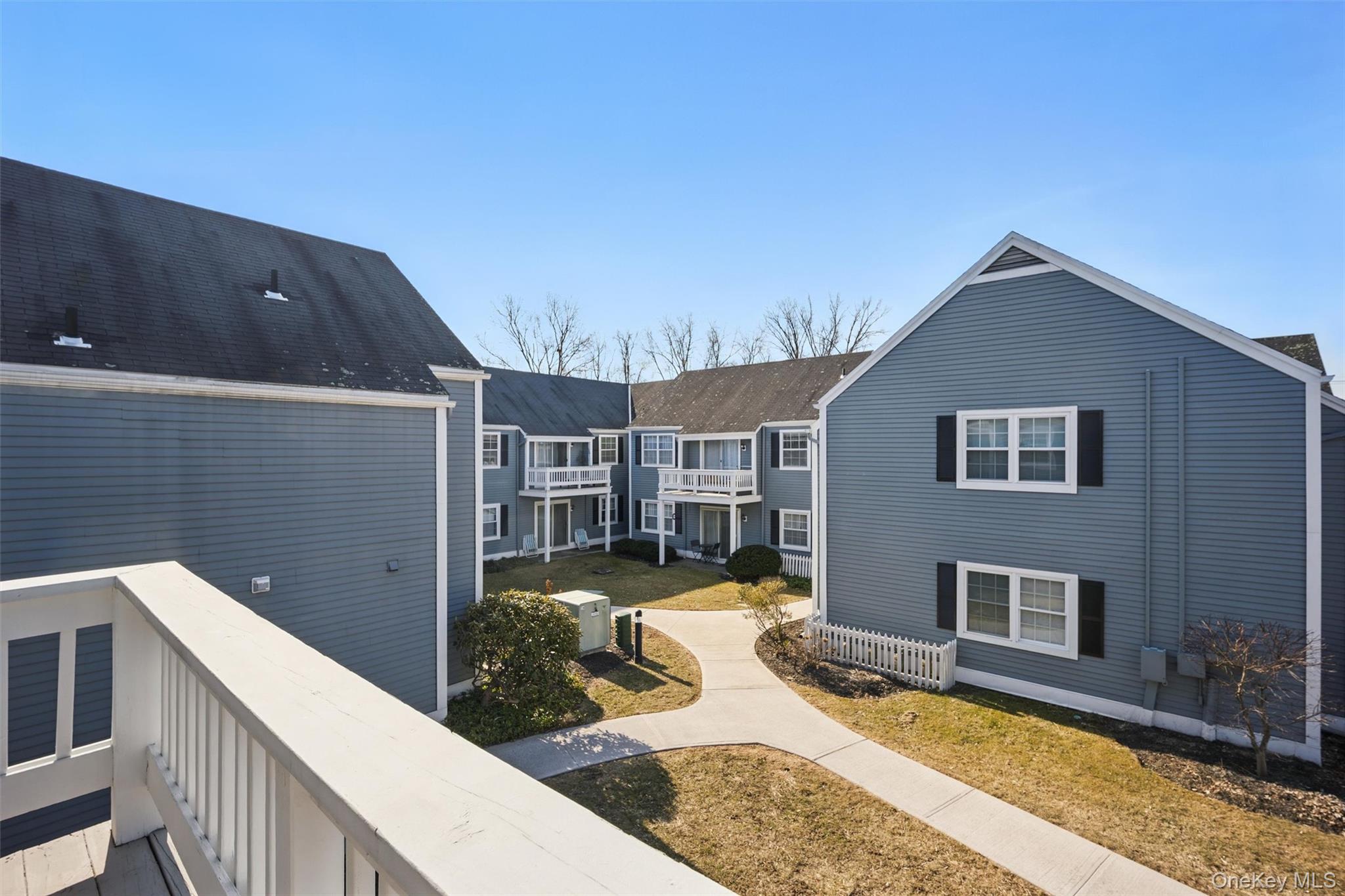 201 Commons Way, Unit E Fishkill, NY 12524 - Photo 27 of 30 a view of a house with backyard and sitting area